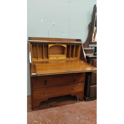 439 - Victorian mahogany drop-front secretary desk with fitted interior compartments and four drawers.