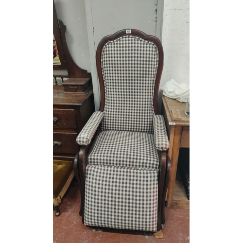 442 - Victorian-style wooden recliner chair features checkered upholstery, a scalloped backrest and armres... 