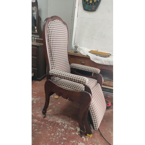 442 - Victorian-style wooden recliner chair features checkered upholstery, a scalloped backrest and armres... 