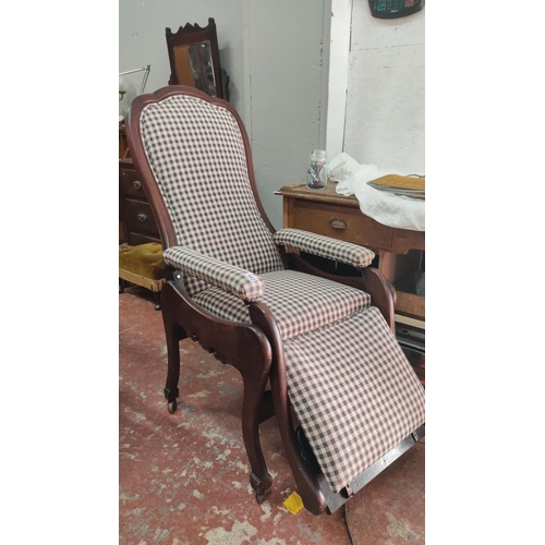 442 - Victorian-style wooden recliner chair features checkered upholstery, a scalloped backrest and armres... 