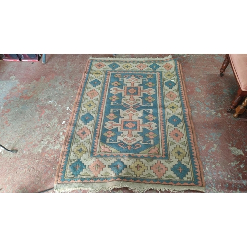 443 - Kilim rug features traditional geometric designs in a palette of blue, coral, green, and cream.