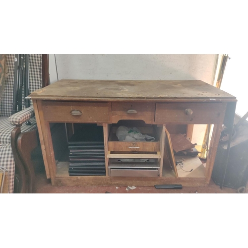 445 - Vintage wooden desk with three upper drawers and open lower compartments, featuring a worn and patin... 