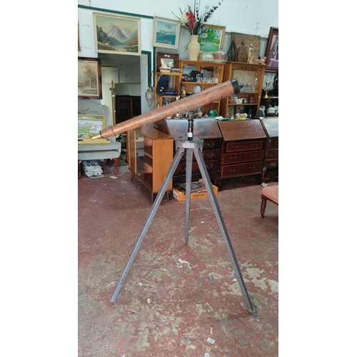 454 - Antique British Military brass and wood telescope mounted on a metal tripod. This vintage piece exud... 