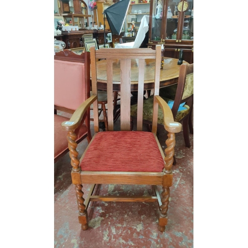 456 - Edwardian oak armchair features barley twist legs and arm supports, a slatted backrest, and a red up... 