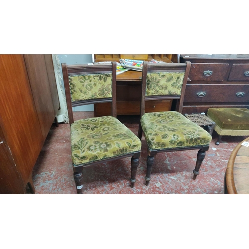 461 - Pair of Victorian dining chairs with floral upholstered seats and backs, featuring turned legs and m... 