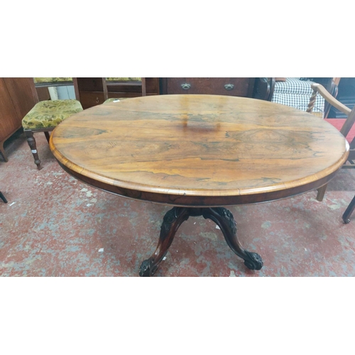 462 - Victorian-era oval tilt-top dining table in rich mahogany with intricately carved pedestal base., me... 