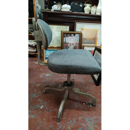 464 - Vintage industrial-style office chair with grey upholstered seat and backrest on a metal base.