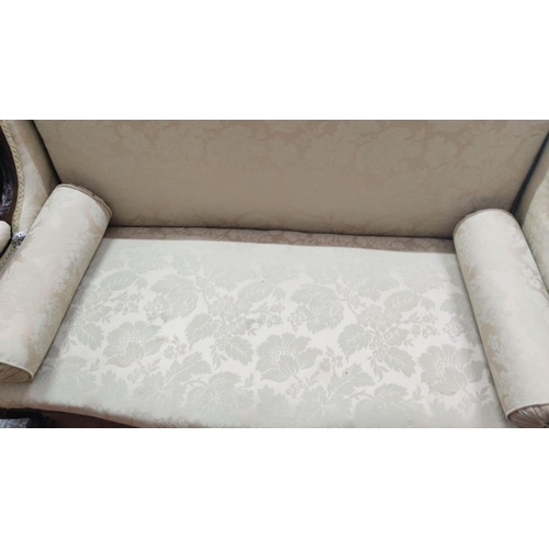 469 - Victorian-style wooden settee with ornate carving. Upholstered in floral-patterned beige fabric, com... 