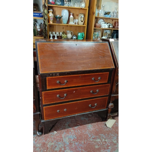 474 - Antique  mahogany bureau with fall front, three drawers, original brass handles, and internal compar... 