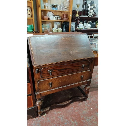 475 - Antique drop-front desk, oak wood, with two drawers and internal compartments.