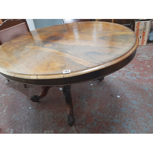 462 - Victorian-era oval tilt-top dining table in rich mahogany with intricately carved pedestal base., me... 