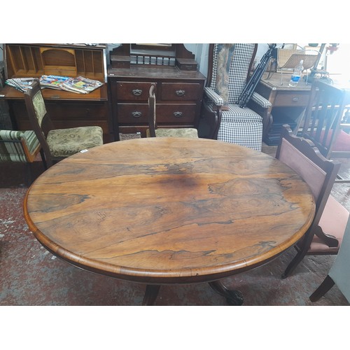 462 - Victorian-era oval tilt-top dining table in rich mahogany with intricately carved pedestal base., me... 