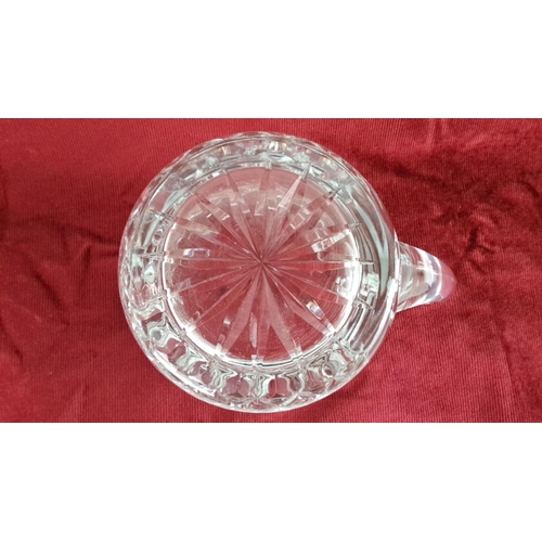 16 - A Waterford crystal jug with diamond pattern design and curved handle. Intricate starburst motif on ... 