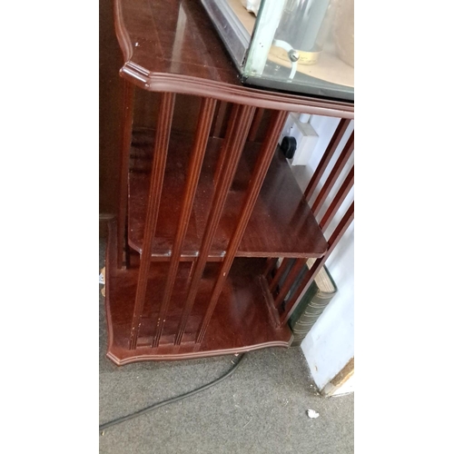 27 - Antique wooden revolving bookcase, mahogany, featuring two-tier shelves and vertical slats.