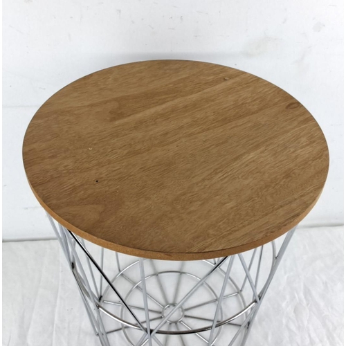 34 - End table with a circular wooden top and geometric metal wireframe base.