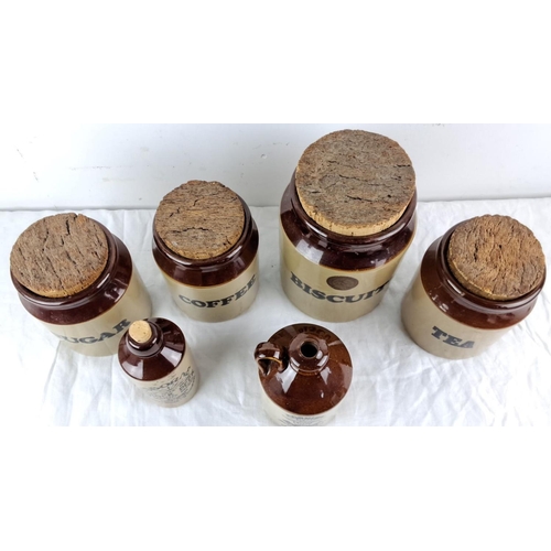 4 - Set of vintage stoneware jars and bottles with cork caps, featuring labeled containers.