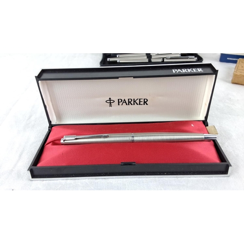 42 - Lot includes a boxed Parker pen, a case with five Parker pens, and three boxes of Parker Quink ink.