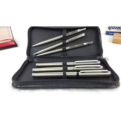 42 - Lot includes a boxed Parker pen, a case with five Parker pens, and three boxes of Parker Quink ink.