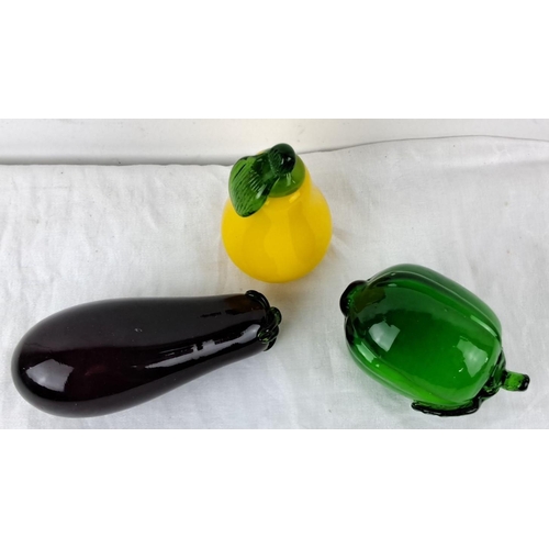 55 - Set of three Murano style glass fruit sculptures in aubergine, yellow pear, and green pepper.