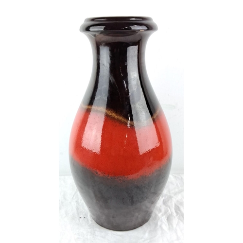 63 - A West German fat lava glazed ceramic vase with a dramatic red and black gradient finish. It feature... 