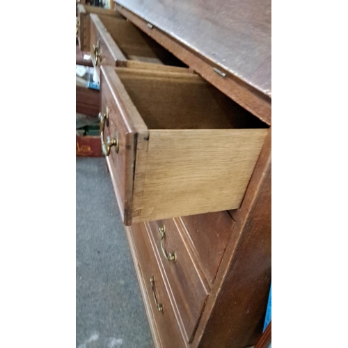 64 - Late Georgian oak bureau with brass handles, featuring a fall-front desk and four graduated drawers ... 