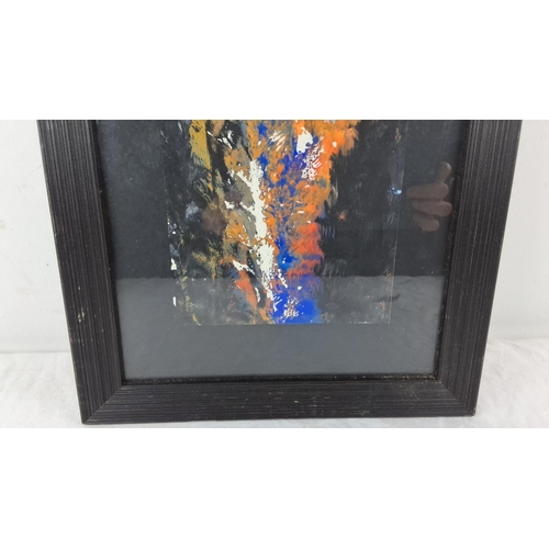 66 - Abstract painting in a black frame featuring vibrant splashes of blue, orange, and white on a dark b... 