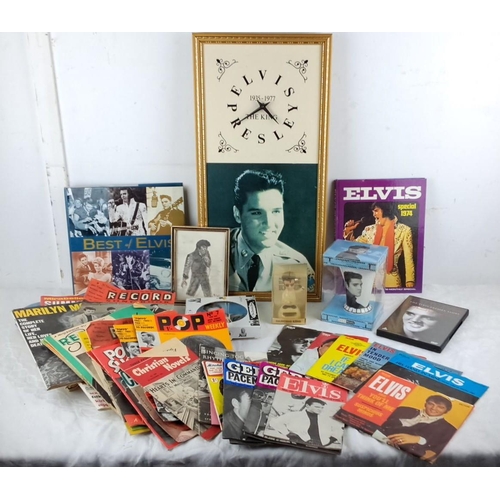 69 - Mixed lot of Elvis Presley memorabilia including framed photos, records, magazines, books, and figur... 