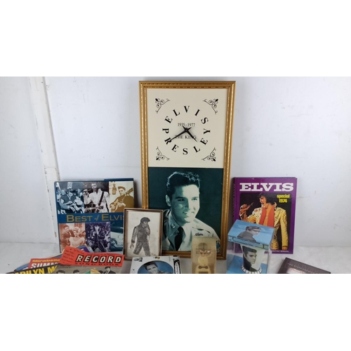 69 - Mixed lot of Elvis Presley memorabilia including framed photos, records, magazines, books, and figur... 