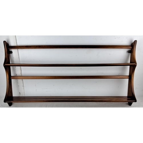 73 - An Ercol oak wood three-tier plate rack with a rich, dark stain has elegantly curved sides and wall ... 