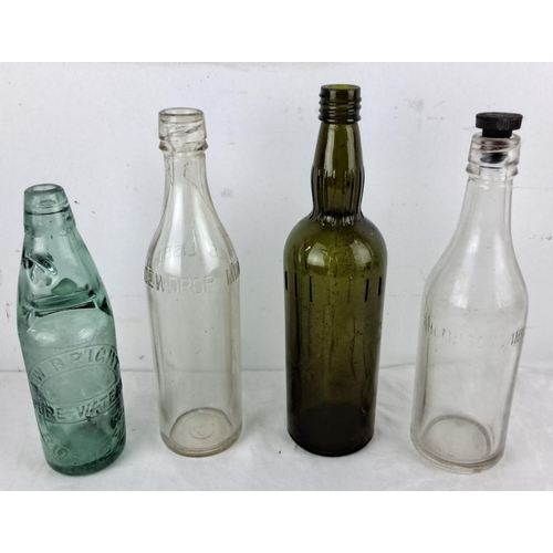 77 - Set of four vintage glass bottles, including an embossed green bottle labeled 