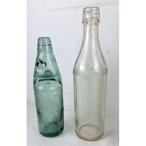 77 - Set of four vintage glass bottles, including an embossed green bottle labeled 