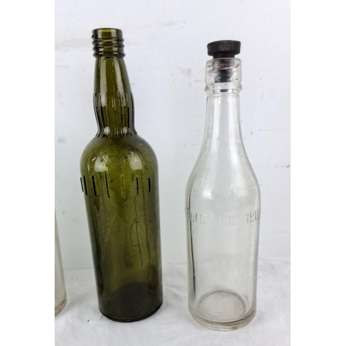 77 - Set of four vintage glass bottles, including an embossed green bottle labeled 