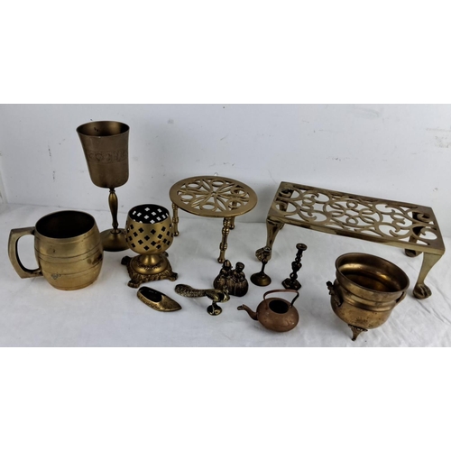 87 - Mixed lot of brass items including goblets, trivet stands, a mug, a candlestick, and assorted small ... 