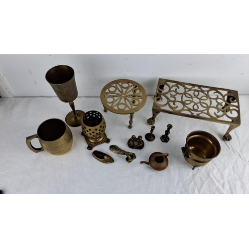 87 - Mixed lot of brass items including goblets, trivet stands, a mug, a candlestick, and assorted small ... 