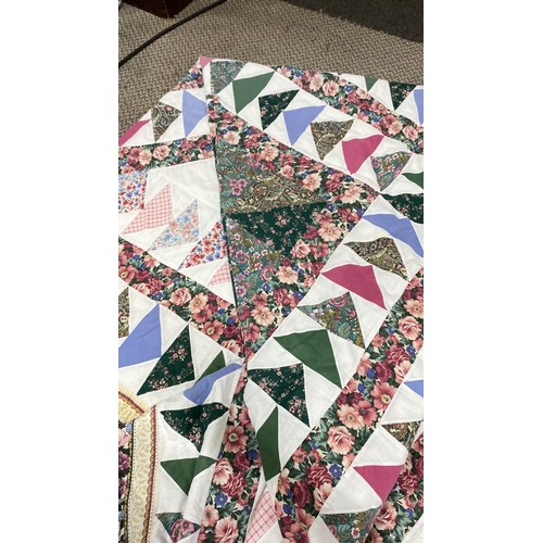 460 - Quilt features a mix of floral and geometric patterns in green, pink, and blue. Fabric combines cott... 