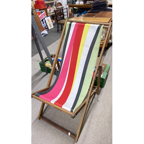 463 - Vintage wooden deck chair with colorful striped fabric seat.