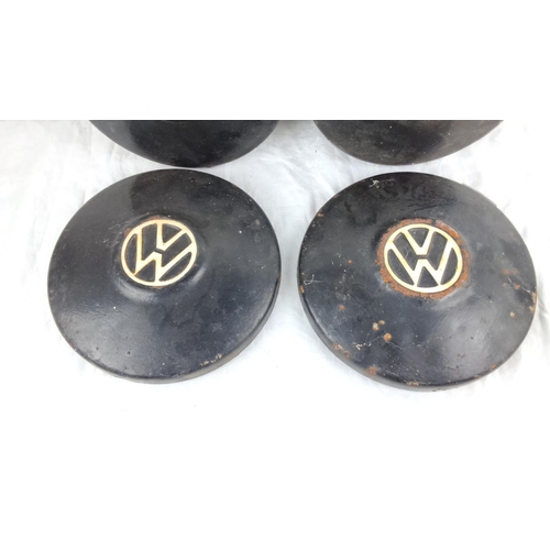 103 - Set of four vintage Volkswagen hubcaps, black with the VW logo.