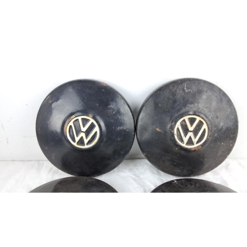 103 - Set of four vintage Volkswagen hubcaps, black with the VW logo.