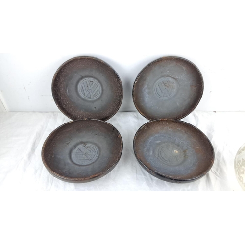 103 - Set of four vintage Volkswagen hubcaps, black with the VW logo.