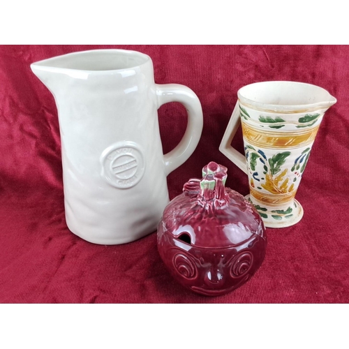 107 - Collection of three ceramic pitchers: a white 