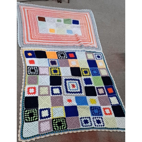 126 - Set of three crocheted blankets, displaying varied geometric patterns and vibrant colors.