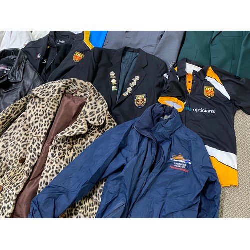 80 - A large assortment of jackets, blazers and coats. To include a Portrush bowls jacket adorned with ba... 