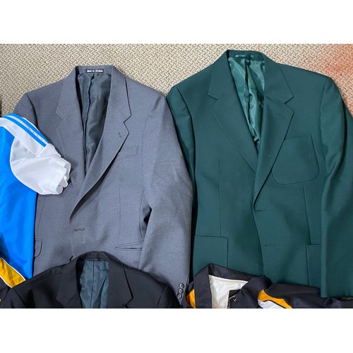 80 - A large assortment of jackets, blazers and coats. To include a Portrush bowls jacket adorned with ba... 