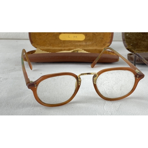 17 - Vintage tortoisell eyeglasses with an accompanying brown leather case, marked 