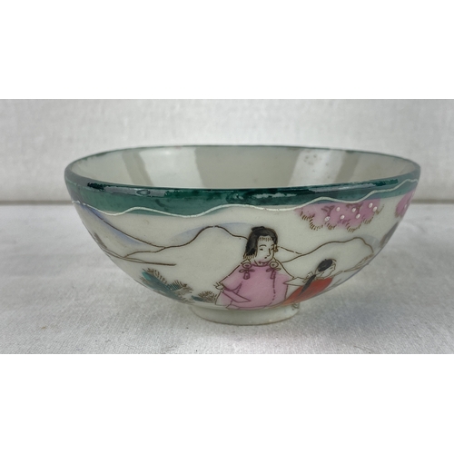 22 - Hand-painted Japanese porcelain bowl, featuring a serene landscape with figures and floral motifs. S... 