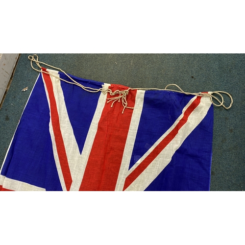 34 - Vintage Union Jack flag, featuring distinctive red, white, and blue fabric with a classic design. In... 