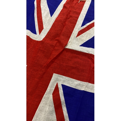 34 - Vintage Union Jack flag, featuring distinctive red, white, and blue fabric with a classic design. In... 