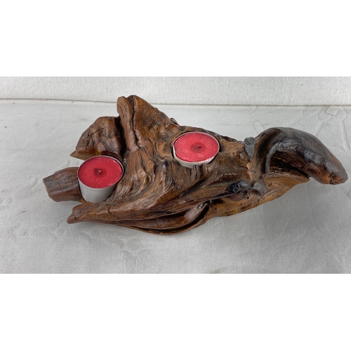 49 - Hand-carved wooden candle holder with organic shape, featuring two red tea light candles.