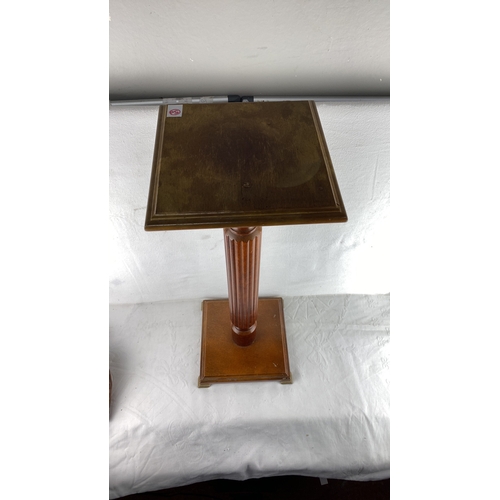 50 - Mahogany pedestal stand, featuring a fluted column with square top and base, period unknown.