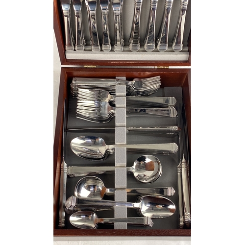 100 - Canteen of Viners cutlery set in a polished wooden case. The set includes knives, forks, spoons, and... 